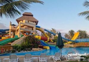 a water park with a water slide in the middle at Rivira Miko 2 in Salalah
