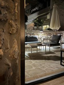 a living room with a table and a chair at Olympus Stone Lodge in Litochoro