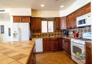 a kitchen with wooden cabinets and a white refrigerator at Casa Talebi El Dorado Ranch San Felipe WiFi in Playa El Paraíso +25 photos