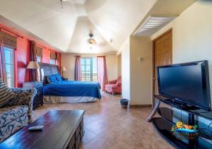 a living room with a bed and a flat screen tv at Casa Talebi El Dorado Ranch San Felipe WiFi in San Felipe