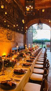 a long table in a room with a long table with candles at Hacienda El Carmen Hotel & Spa in Portes Gil +60 photos