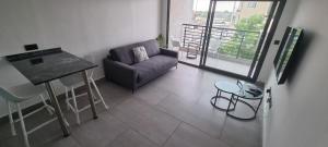a living room with a couch and a table at Amal Suites in Accra +4 photos