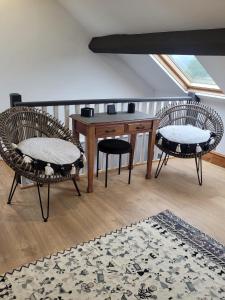 a room with two chairs and a wooden table with a rug at Snowdon view, steam railway & Portmeirion nearby in Mynfford