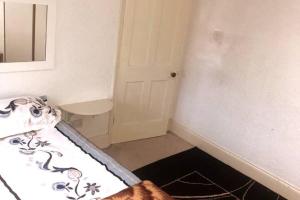 a small bedroom with a bed and a mirror at Budgeted Residence near Coventry Building Society (CBS) Arena with Parking in Exhall