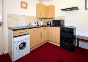 a kitchen with a washing machine and a washer at Entire apt. quiet area near Leeds Castle Maidstone in Harrietsham