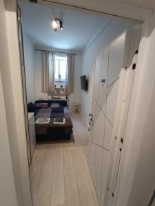 a small room with a bed and a room with a door at Astralis Factory Apartments- Mars & Venus in Zagreb