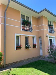 a house with flower boxes on the windows at Horváth Apartman in Balatonlelle