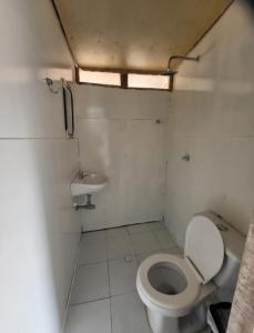 a small bathroom with a toilet and a sink at Venido Del Mar. Neymar in Baru