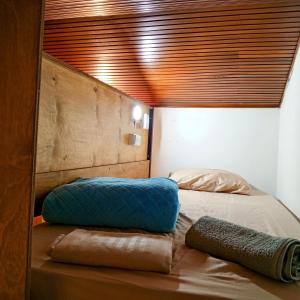 a bedroom with a blue pillow on a bed at Kuyay Hostel in Bogotá