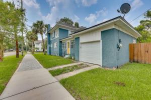 a blue house with a fence and a grass yard at Pet friendly home in Historic Springfield near TIAA in Jacksonville