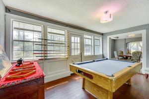 a pool table in a room with windows at Pet friendly home in Historic Springfield near TIAA in Jacksonville