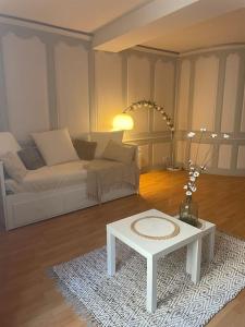 a living room with a couch and a coffee table at « Au cœur de Dole » in Dole +9 photos