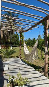 a hammock is hanging from a wooden structure at Villa Mediterránea in Tubará