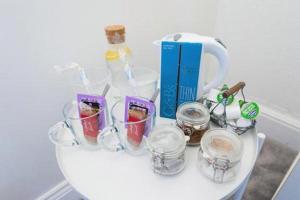 a white table with glasses and bottles on it at The Blackwater Suite in Colchester