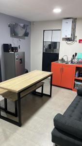 a kitchen with a wooden table in a room at SaVilie 2 - Seguridad y Comfort in Guadalajara