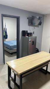 a room with a wooden table and a refrigerator at SaVilie 2 - Seguridad y Comfort - Con Terraza in Guadalajara