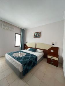 Postel nebo postele na pokoji v ubytování Best Hotel