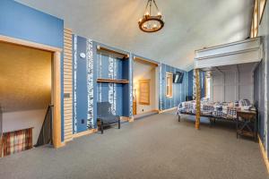 a bedroom with blue walls and a bed at Spacious Old Forge Condo w/ Patio & Fire Pit! in Old Forge