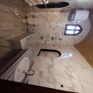 a dirty bathroom with a toilet and a sink at Mystical habou domes villa private pool in Luxor +50 photos