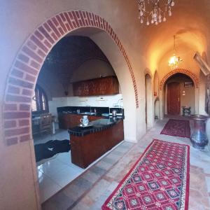 a large kitchen with an archway in a house at Mystical habou domes villa in Luxor