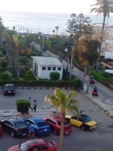 a group of cars parked in a parking lot near the ocean at Salvatore Room With Breakfast- Garden View in Alexandria