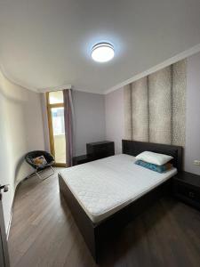 a bedroom with a large bed and a window at Orbi Plaza Black Sea in Batumi