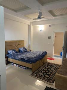 a bedroom with two beds and a ceiling at Bhurban Luxury Apartments in Bhurban
