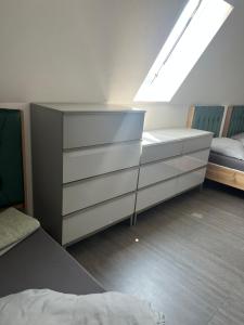 a bedroom with a dresser and a bed and a window at Aurela Home in Murg