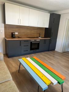 a kitchen with a colorful bench in the middle of a room at Aurela Home in Murg