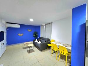 a living room with a couch and a table and chairs at סוויטת מרלו - Merlot Suite in Eilat +4 photos