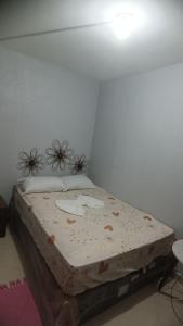 a bed sitting in a corner of a room at Casa temporada ilheus in Ilhéus