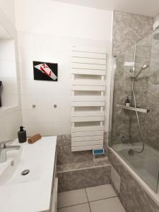 a bathroom with a shower and a sink and a shower at Chez Mamarina - Quadruplex - Marina Deauville in Deauville