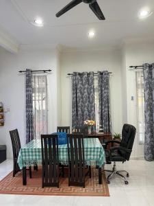 a dining room with a table and chairs at Homestay Seri Aman Pasir Puteh 