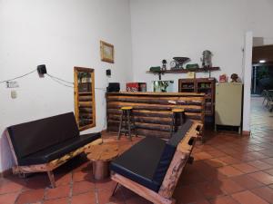 una sala de estar con un banco y un bar en HOSTERÍA BRISAS DEL RÍO, en Marinilla
