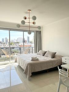 a bedroom with a large bed and a large window at Monoambiente Luxury in Buenos Aires