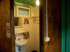 a small bathroom with a sink and a mirror at Beach Box Resort at Rimlay Rayong in Rayong