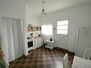 a kitchen with a stove and a sink in it at Hospedaje DCB in Capilla del Monte