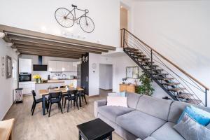 a living room with a couch and a staircase at NIMA Cozy Stay Mlini in Mlini