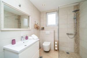 a bathroom with a toilet and a sink and a shower at NIMA Cozy Stay Mlini in Mlini +53 photos