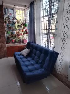 a blue couch in a room with a window at Apartamento frente al castillo San Felipe in Cartagena de Indias