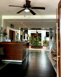 a lobby with a ceiling fan and a reception desk at Vigan Living in Vigan