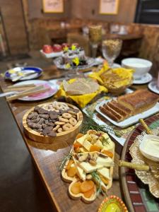 a table topped with lots of different types of food at Solar do Oriente - Yurt Ecovillage in São Joaquim