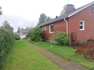 a brick house with a dirt road next to it at Villa med egen parkering. Möjlighet att boka från 1 och upp till 5 personer. in Örebro