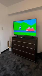 a flat screen tv sitting on top of a dresser at Condo in Manila