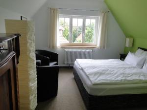 Llit o llits en una habitació de Pension Villa am Burgberg