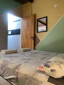 a bedroom with a large bed with a window and a door at Hostal - Sueños del Rio in Concepción del Uruguay