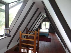 um quarto com uma escada com uma cama e janelas em Cabaña Tribu 