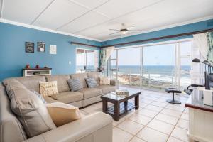 a living room with a couch and a view of the ocean at Breathtaking views from Sue Casa 11 in Margate
