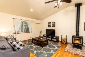 a living room with a couch and a fireplace at Nature's Nook - Blissful Cabin in the Woods in Placerville