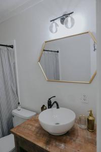 a bathroom with a sink and a mirror on a counter at Dream On – Style & Comfort Near Historic Downtown in Panama City